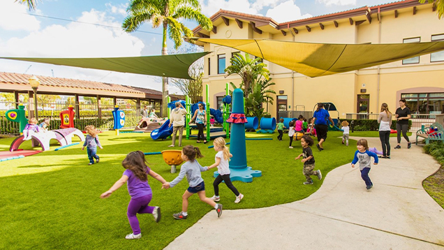 Kids playing outside of the Jim and Jan Moran family center village
