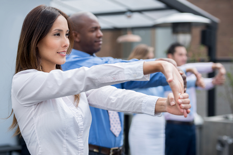 Group of people stretching their arms