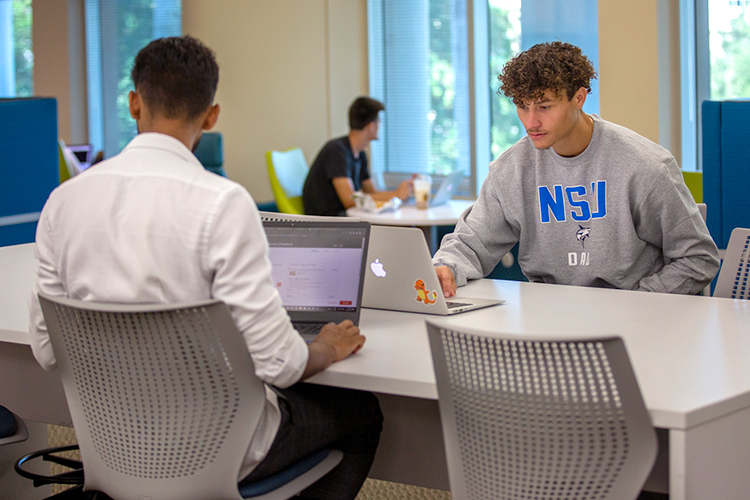 Group of students using their laptops