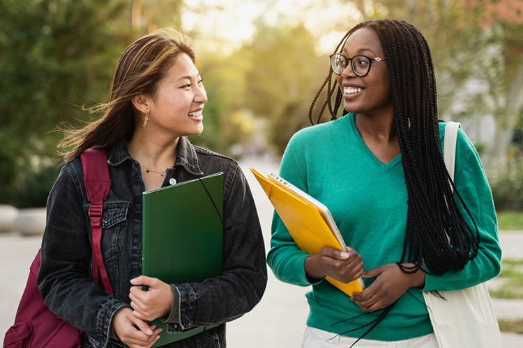 Two students smiling outside