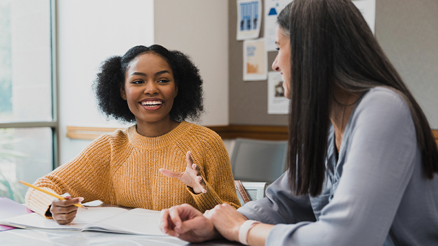 Student talking to a woman in class