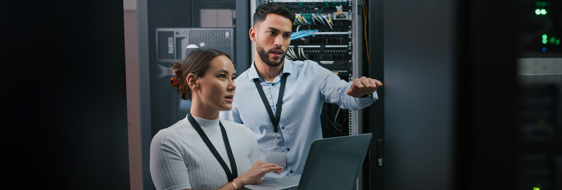 Two people working together in a server room