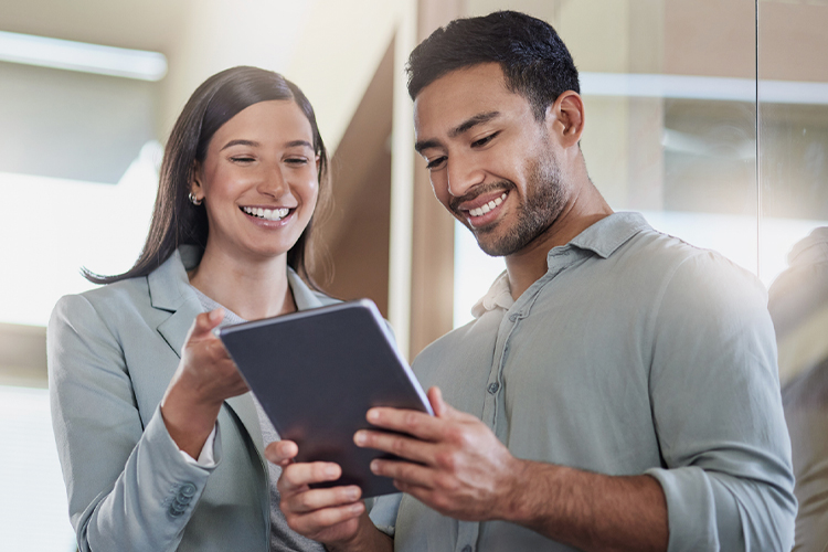 Man and woman talking while using a digital tablet