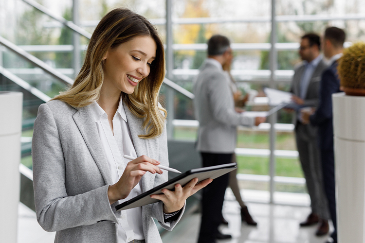 Woman using a digital tablet in the lobby