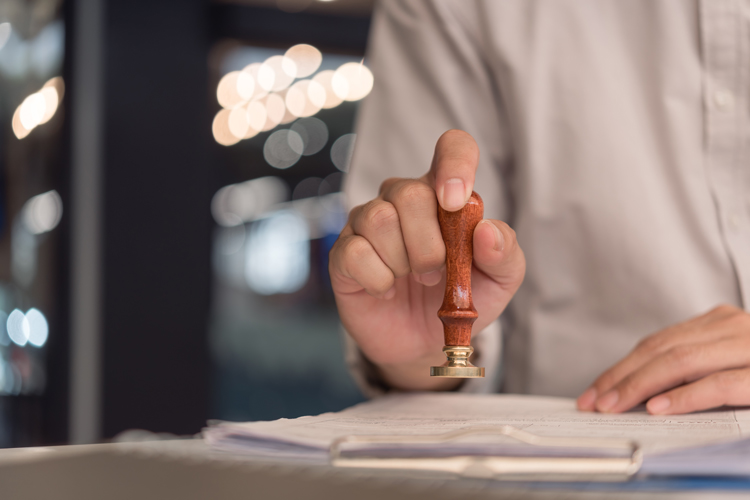 Person using apostille seal closeup