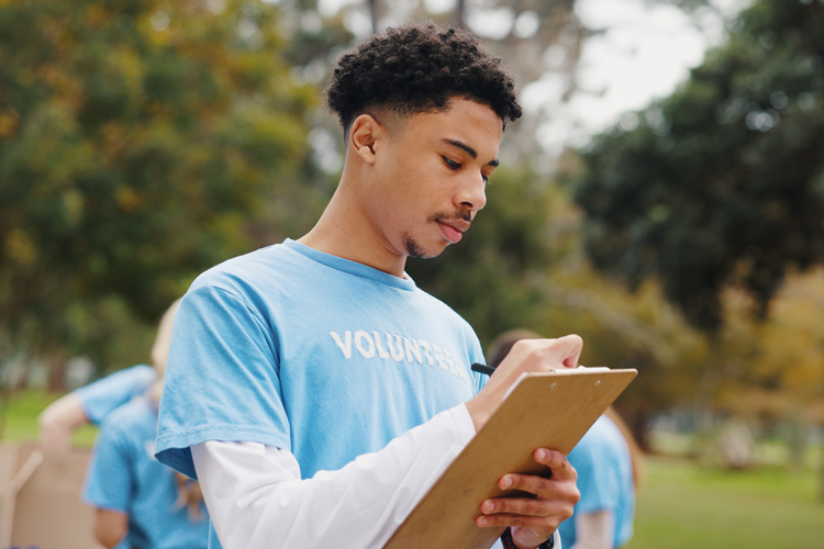 Student doing service hours tracking on clipboard