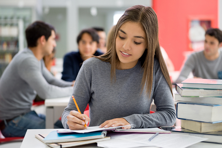 Student studying and taking notes