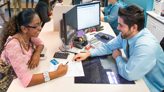 Counselor helping student with documents.