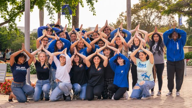 Group of nevada campus students with their fins up 